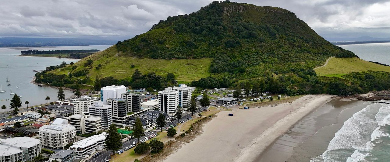 Aerial view of Mount Maunganui with its buildings, coastline and the ocean in Tauranga